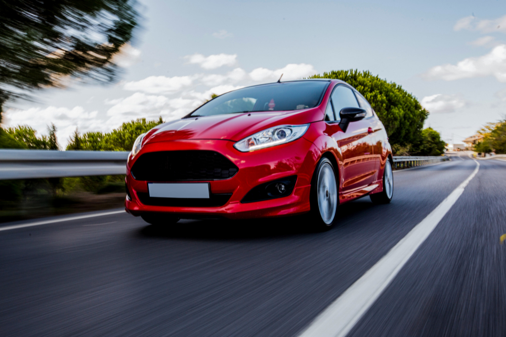 red-mini-coupe-driving-highway-with-high-speed