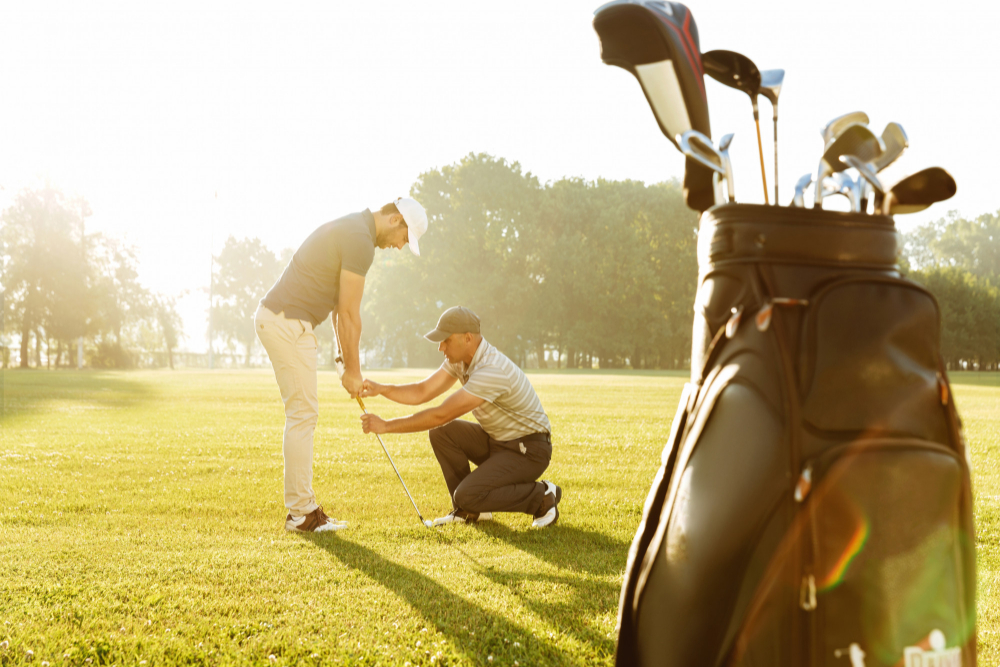 personal-trainer-giving-lesson-young-male-golfer