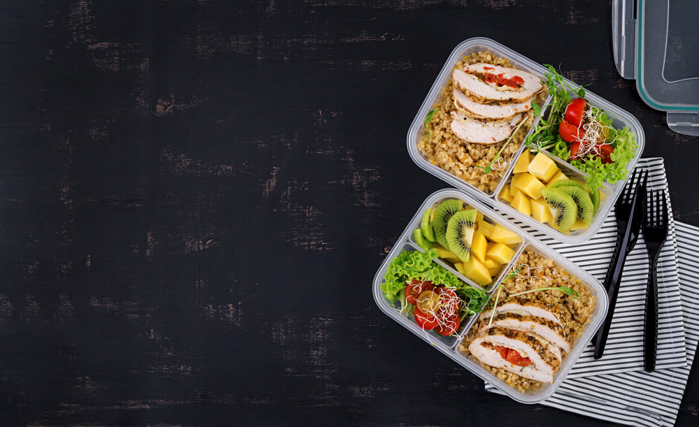 lunch-box-chicken-bulgur-microgreens-tomato-fruit-healthy-fitness-food-take-away-lunchbox-top-view