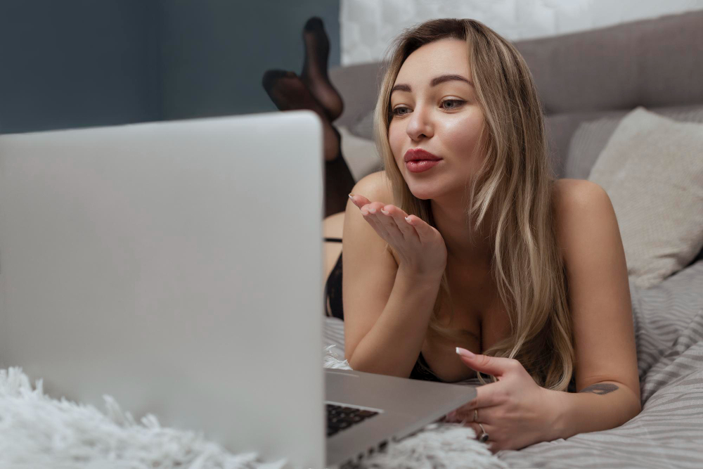 beautiful-young-girl-shoots-webcam-blows-kiss-into-camera-works-as-model-concept-online-flirting-sex-internet